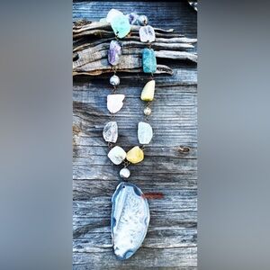 Rutilated stones with a gray agate slab.